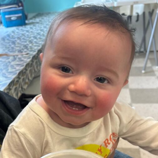 Smiling baby at The Club House childcare center.